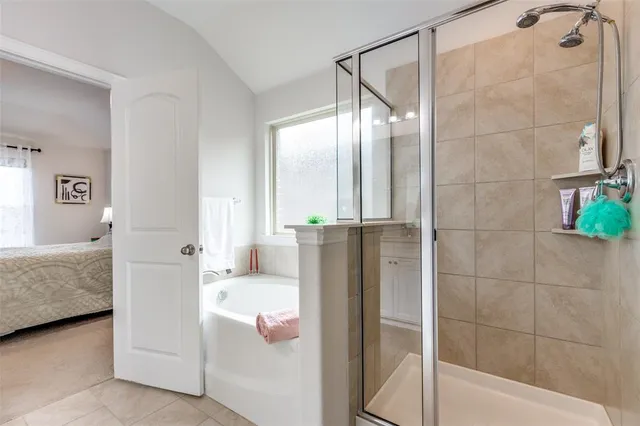a bathroom with a tub shower and a sink