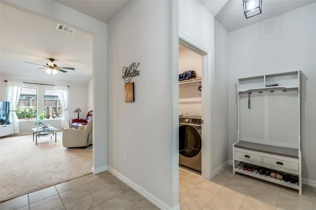 a view of a hallway with workspace and a window