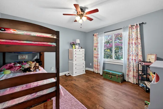 a view of a kids room with toys and a chandelier