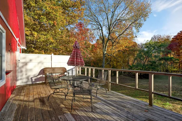 a view of a chairs and table on the wooden deck