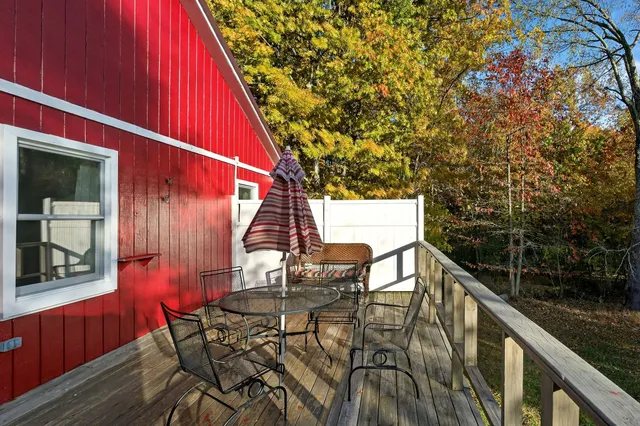 a view of deck with furniture and trees