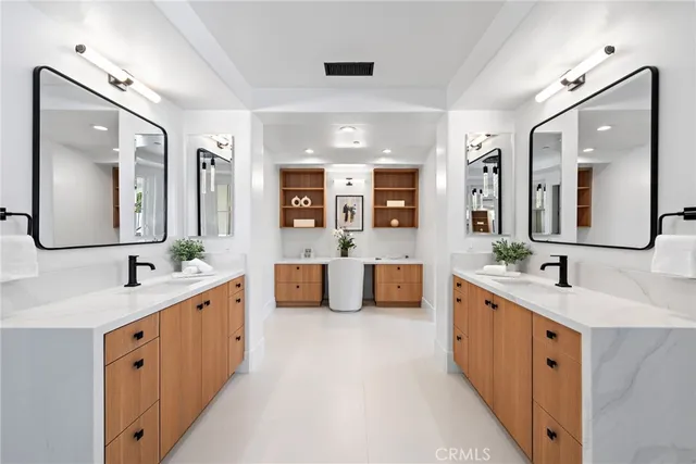 a spacious bedroom with a bed and a dresser