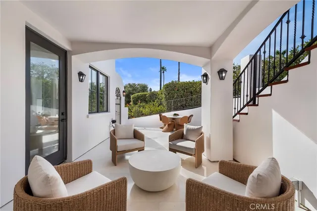 a bedroom with a large bed and a potted plant