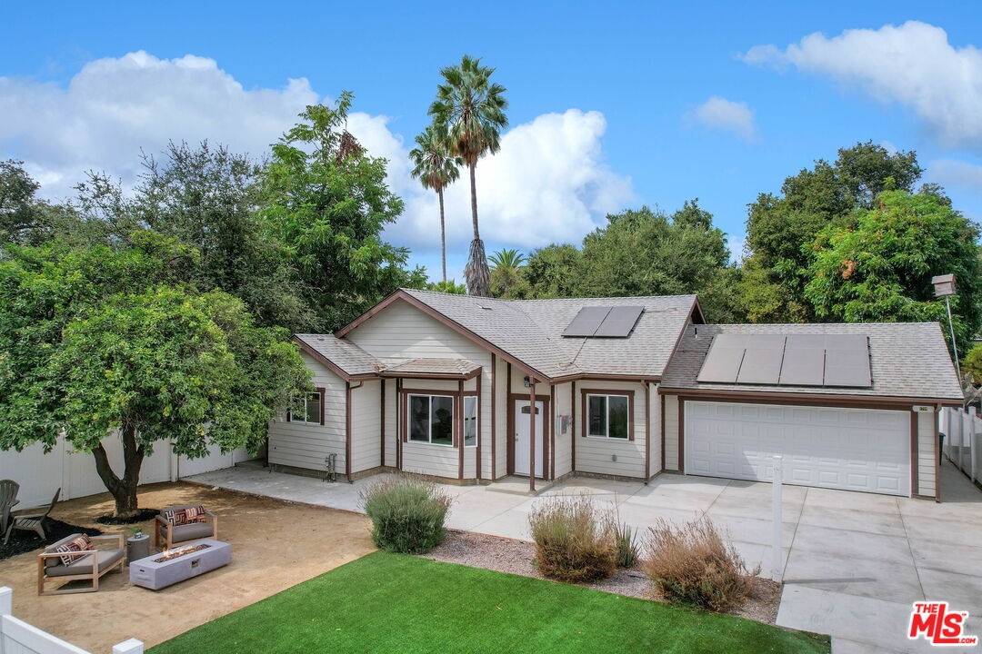 a view of a house with backyard porch and sitting area