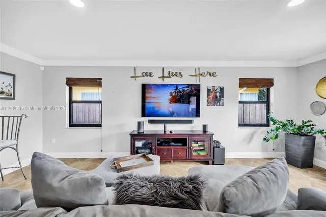 a view of a dining room with furniture a rug and wooden floor