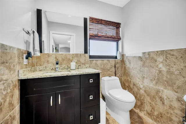 a spacious bedroom with a bed and a chandelier