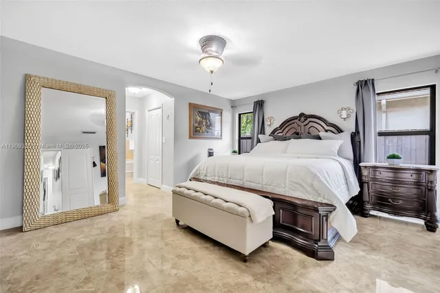 a bedroom with bed and flat screen tv