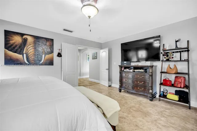 a bedroom with bed and window