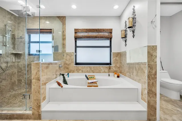 a bathroom with a tub sink and mirror