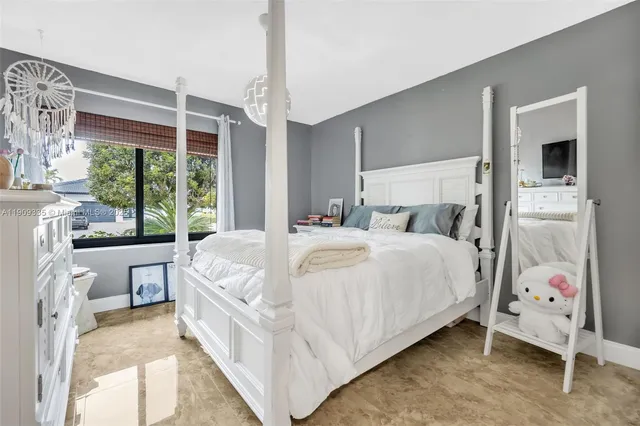 a bedroom with a bed and window