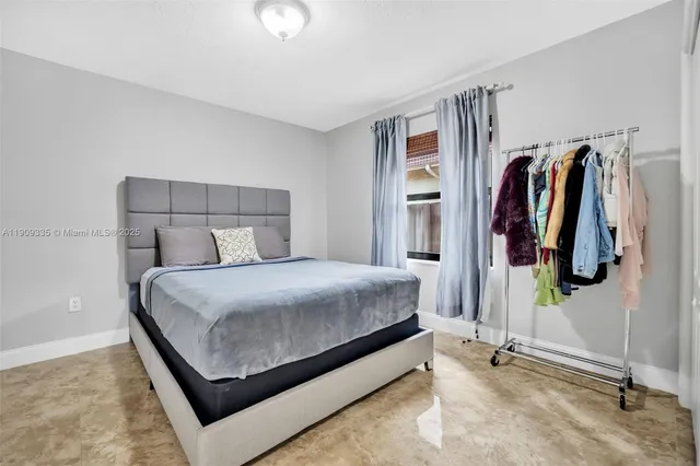 a bedroom with a bed and a view of bathroom