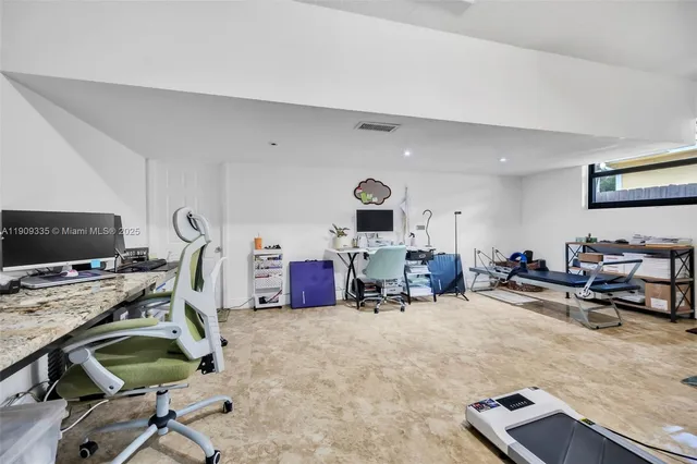 a living room with furniture and white walls