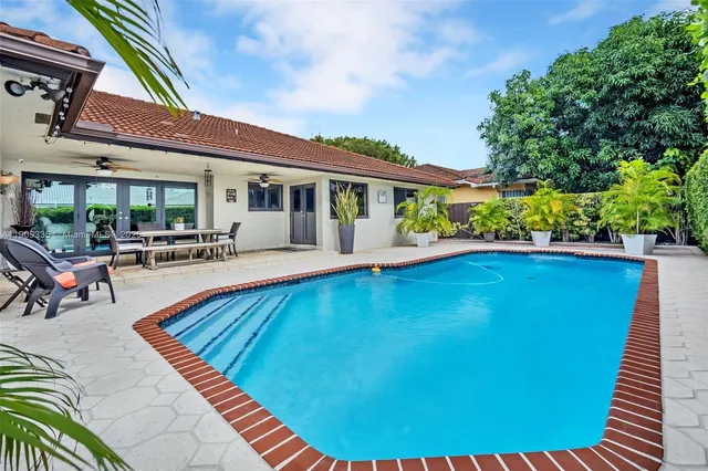 a view of swimming pool with outdoor seating