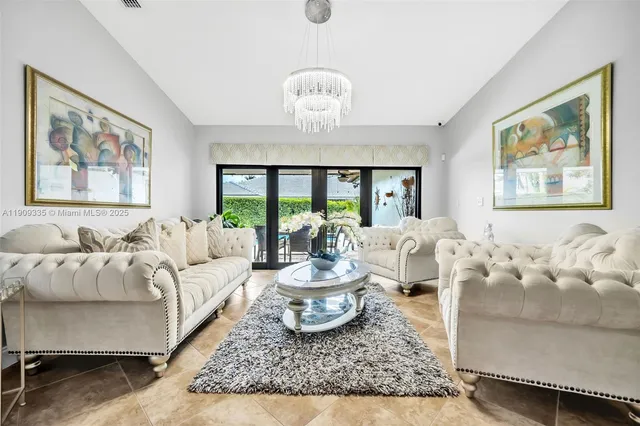 a living room with furniture large window and outdoor view