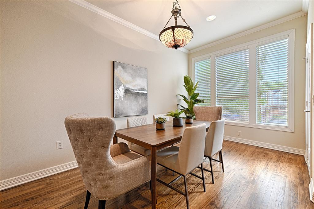 6269 Oram Street, Unit 10 Dallas, TX 75214 - Photo 10 of 25 a dining room with furniture a chandelier and wooden floor