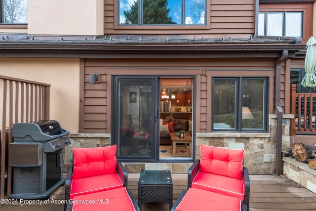 a backyard of a house with outdoor seating
