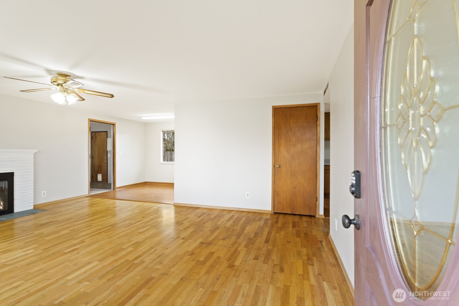 12742 Southeast 171st Place Renton, WA 98058 - Photo 11 of 33 a view of an empty room with wooden floor and a window