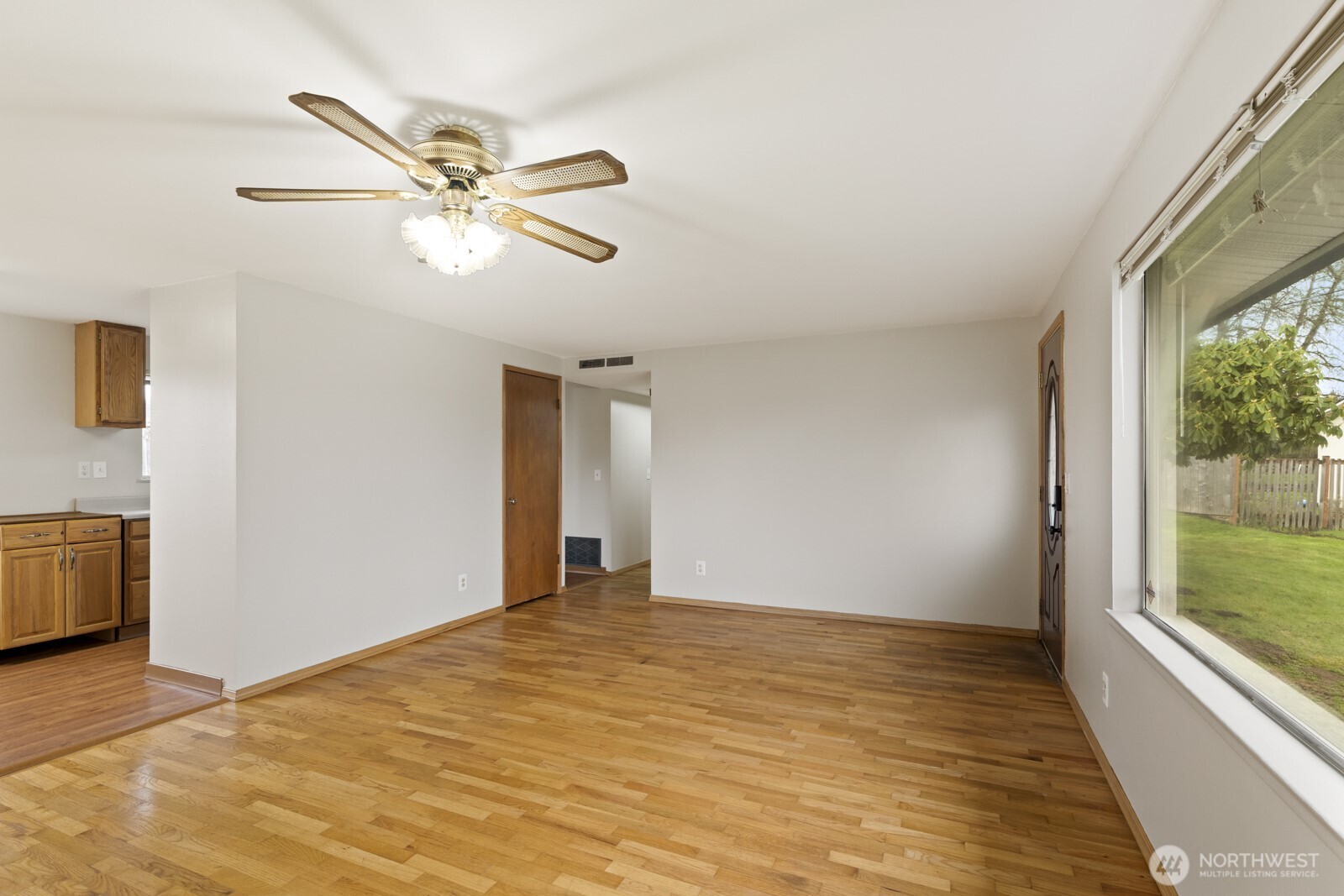 12742 Southeast 171st Place Renton, WA 98058 - Photo 14 of 33 a view of empty room with wooden floor and fan