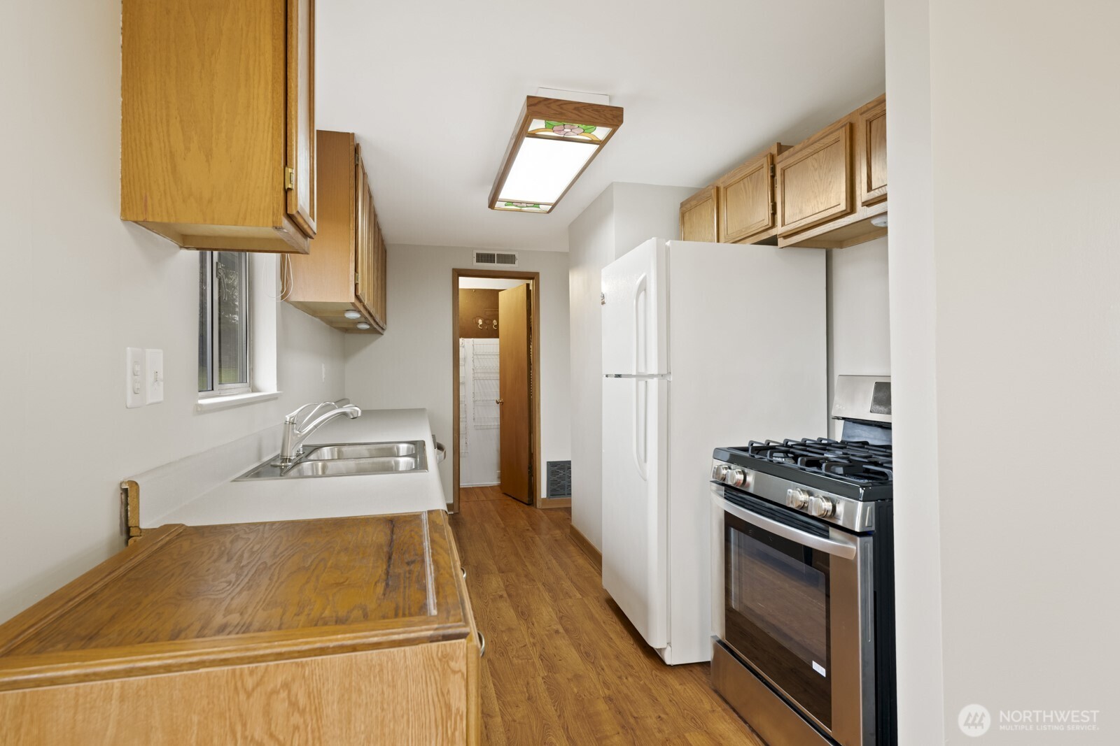 12742 Southeast 171st Place Renton, WA 98058 - Photo 17 of 33 a kitchen with stainless steel appliances granite countertop a stove and a refrigerator
