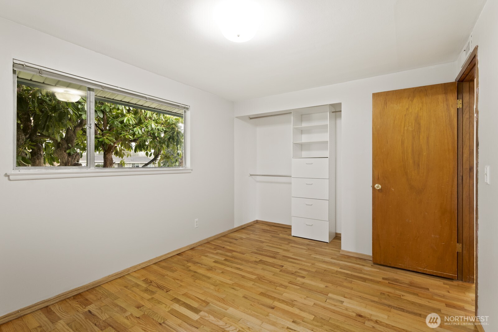 12742 Southeast 171st Place Renton, WA 98058 - Photo 22 of 33 a view of empty room with wooden floor and fan