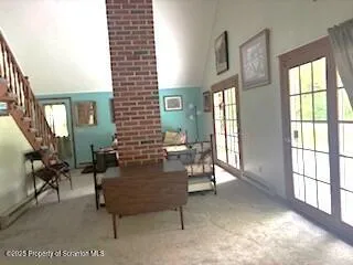 a kitchen with a table chairs refrigerator and cabinets