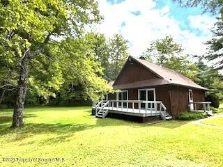 a view of a house with swimming pool and sitting area