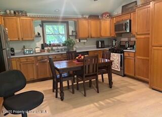 1087 Canada Road Friendsville, PA 18818 - Photo 25 of 72 a kitchen with a dining table chairs and a refrigerator