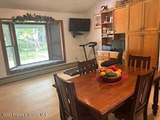 1087 Canada Road Friendsville, PA 18818 - Photo 26 of 72 a dining room with furniture and a flat screen tv