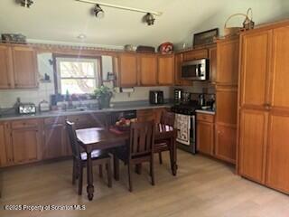 1087 Canada Road Friendsville, PA 18818 - Photo 27 of 72 a kitchen with granite countertop a sink appliances and cabinets