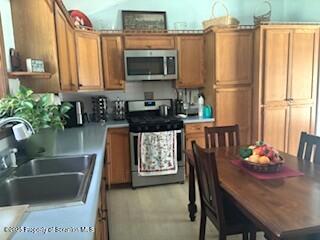 1087 Canada Road Friendsville, PA 18818 - Photo 29 of 72 a kitchen with stainless steel appliances granite countertop a refrigerator a stove top oven a sink dishwasher and dining table with wooden floor