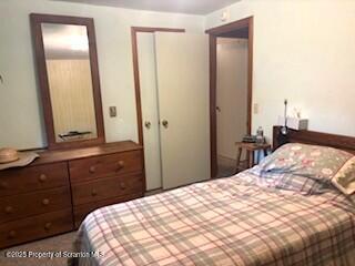 1087 Canada Road Friendsville, PA 18818 - Photo 33 of 72 a bedroom with a bed and a mirror