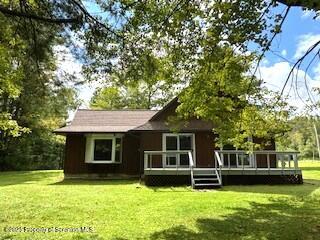 1087 Canada Road Friendsville, PA 18818 - Photo 4 of 72 a backyard of a house with yard table and chairs