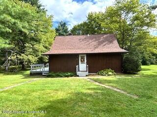 1087 Canada Road Friendsville, PA 18818 - Photo 5 of 72 a view of a yard in front of a house with large tree