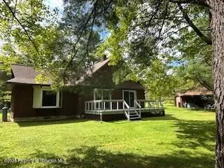 a front view of a house with a yard table and chairs