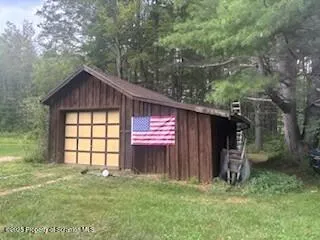 a view of a dinning table and chairs in the garden