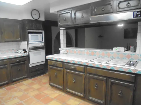 a kitchen with cabinets and stainless steel appliances