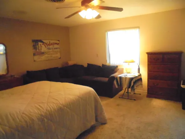 a bed sitting in a bedroom next to a window