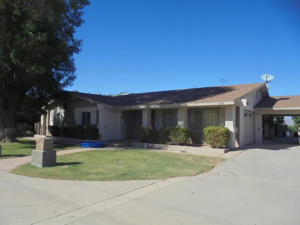 a front view of a house with a yard and porch
