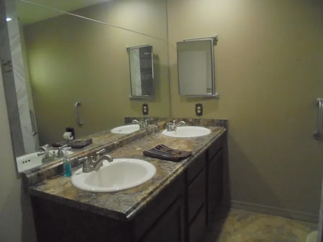 a bed sitting in a bedroom next to a bathroom