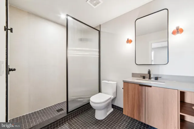 a bathroom with a toilet sink and shower