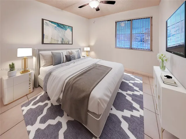 a bedroom with a bed and a painting on the wall