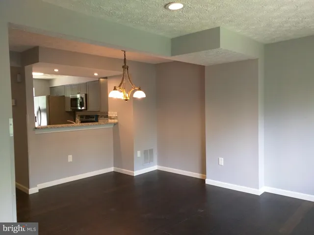 a view of a kitchen with a sink and cabinets