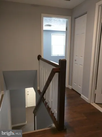 a view of entryway and hall with wooden floor