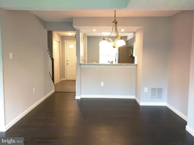 a view of a room with wooden floor and windows