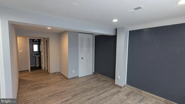 a view of hallway with wooden floor