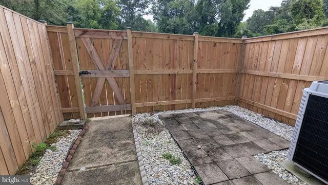 a view of a backyard with wooden fence