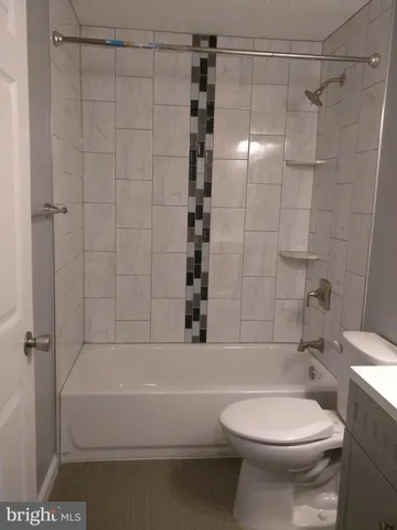 a bathroom with a toilet and shower