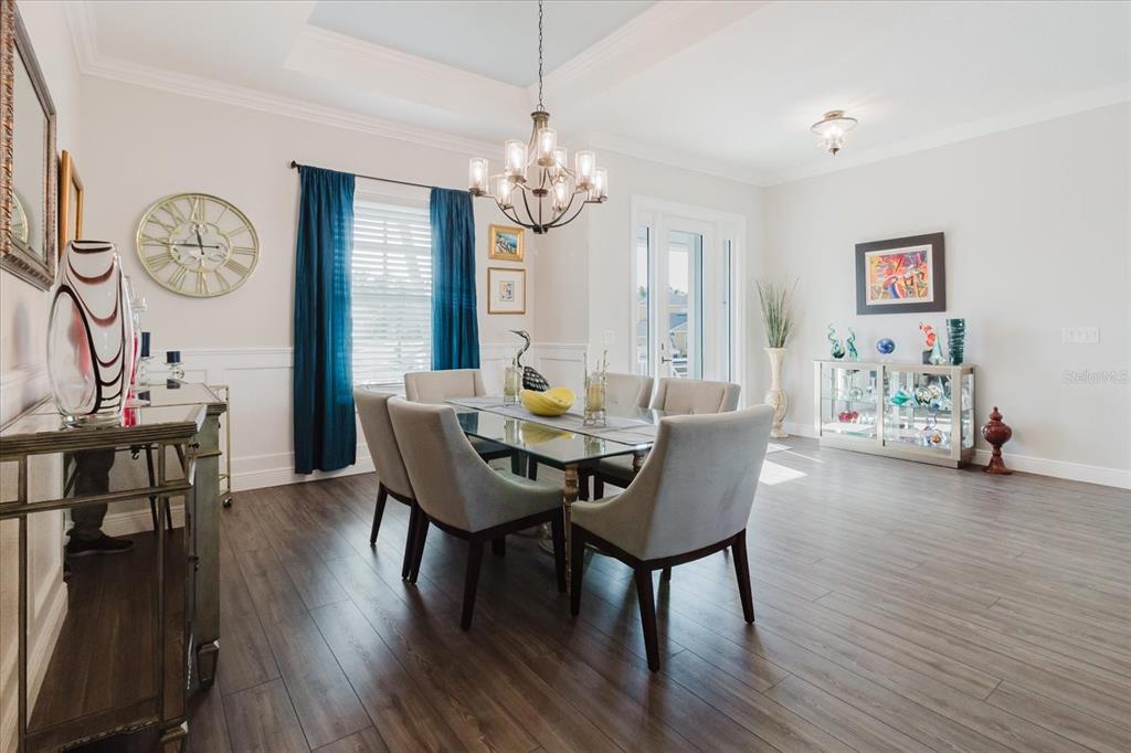 216 High Street Tarpon Springs, FL 34689 - Photo 12 of 75 a view of a dining room with furniture a chandelier and wooden floor