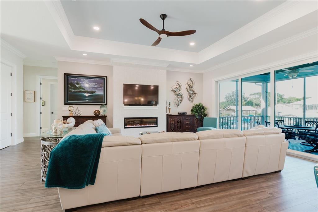 216 High Street Tarpon Springs, FL 34689 - Photo 17 of 75 a living room with furniture tv and a large window