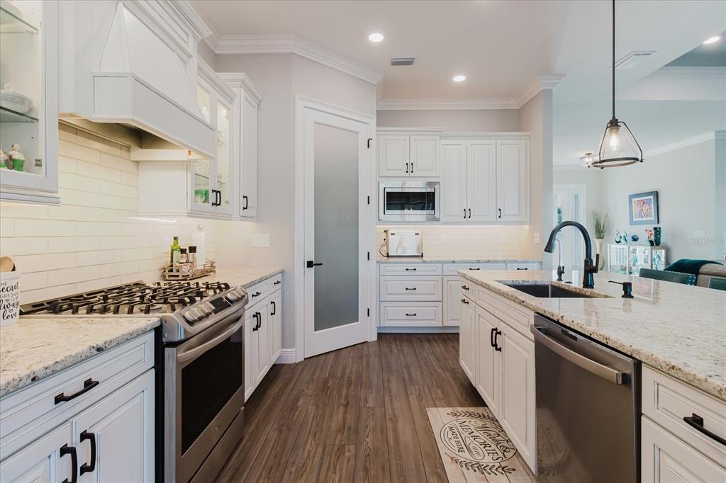216 High Street Tarpon Springs, FL 34689 - Photo 25 of 75 a kitchen with stainless steel appliances a sink stove and cabinets